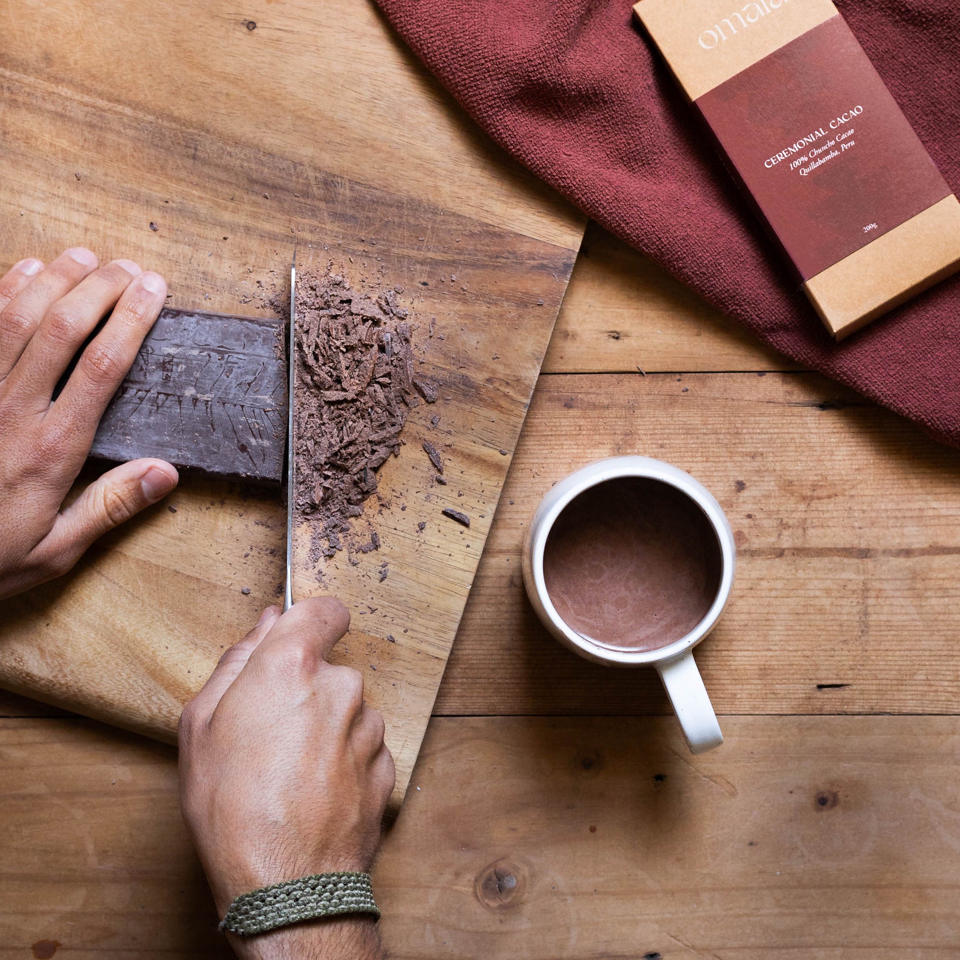 Chopping a block of Omala ceremonial grade cacao for drinking.